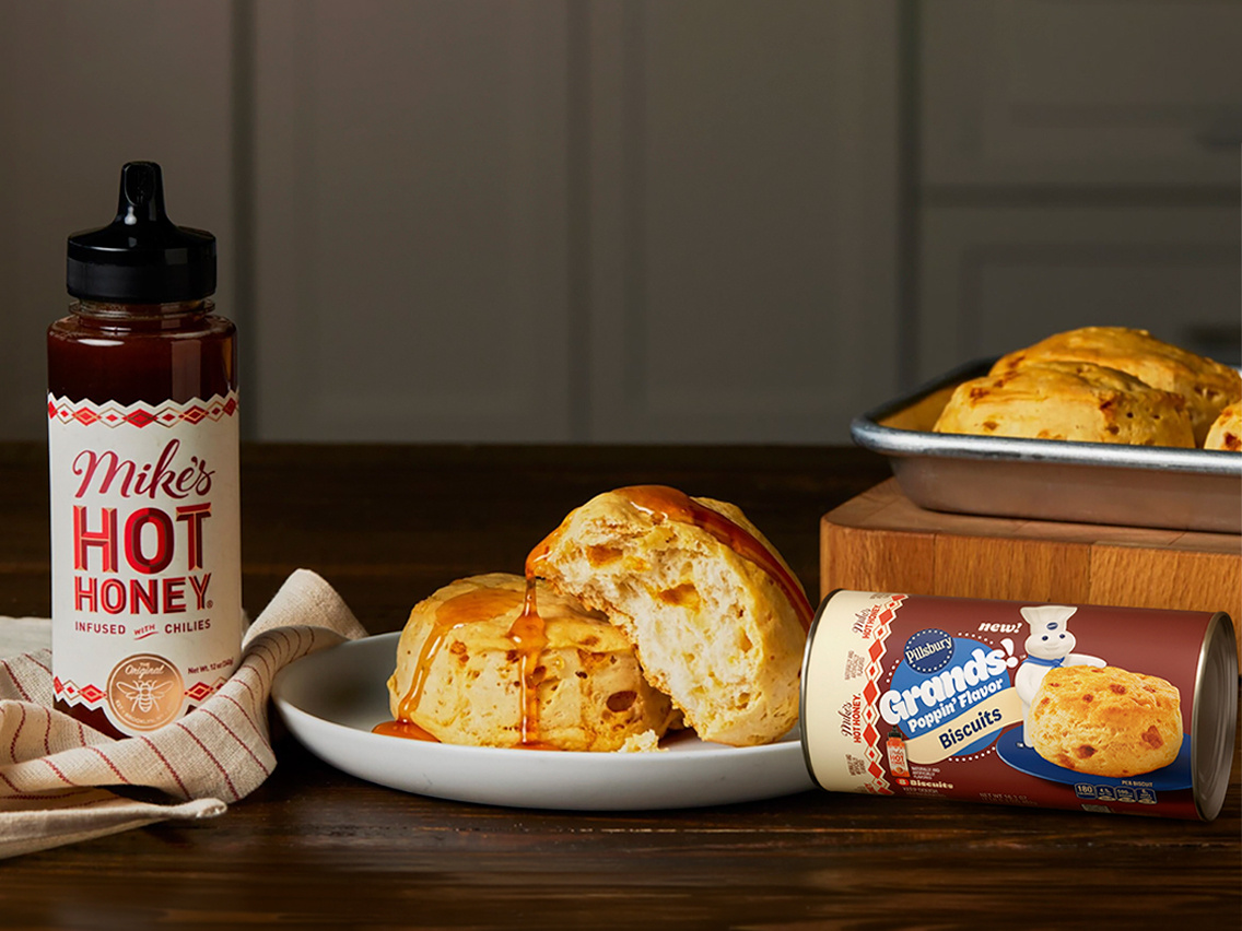 Pillsbury’s ready-to-bake Hot Honey and Maple Biscuits, plus Raspberry and Apple Fruit Rolls plated on a kitchen table.