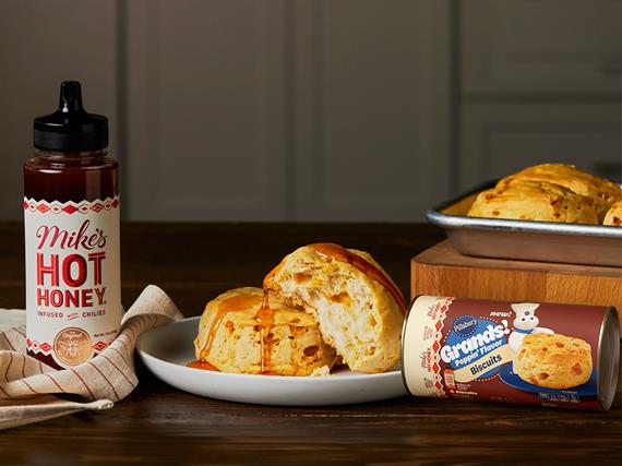 Pillsbury’s ready-to-bake Hot Honey and Maple Biscuits, plus Raspberry and Apple Fruit Rolls plated on a kitchen table.